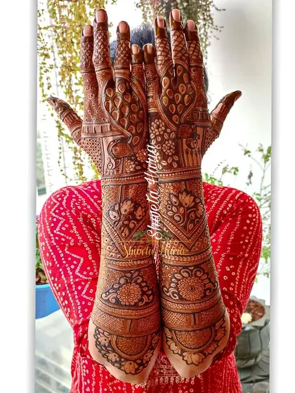 A beautiful example of a heavy Indian back-hand design. This style provides full coverage with a stunning mix of peacocks, florals, and meenakari-style bold patterns.