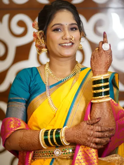 A playful pose from the bride, showing off her ring. The makeup is celebratory and fun, just like the occasion.
