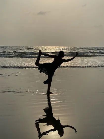 The reflection of this Dancer's Pose on the wet sand looks like a watercolor painting. It’s a beautiful capture of a New Year's moment in Goa, celebrating new beginnings with balance and grace.