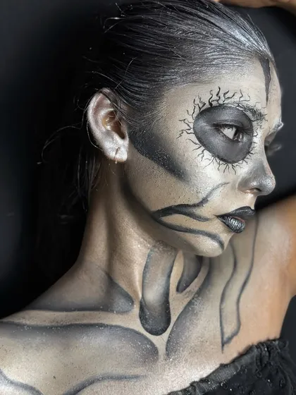 A profile view of the creative skeletal makeup, highlighting the shading and dimension created on the face and neck.