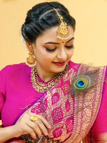 A creative shot with a peacock feather, adding a touch of traditional artistry to this beautiful portrait.