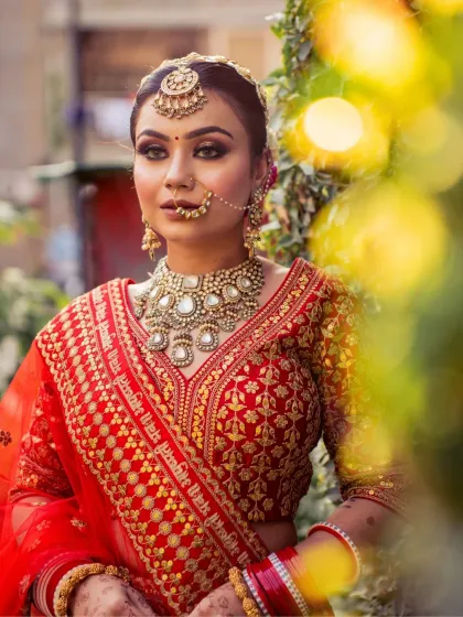 A lovely outdoor shot with beautiful bokeh. The bride's makeup, with its glittery eyes and flawless base, looks stunning in the natural light.