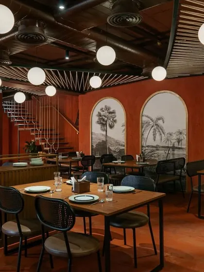 For the 'Chambal' restro-bar, I used a monochromatic palette of rustic red and exposed brick to create a warm, immersive dining experience. The design, including the globe pendant lights, evokes a sense of rustic celebration while maintaining a modern, open-plan layout.