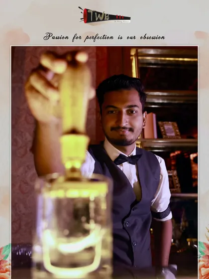 A bartender presents a crystal-clear clarified cocktail, a testament to our advanced mixology techniques that result in a smoother, more refined flavor profile.