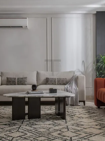 Inspired by Scandinavian design, this drawing room features furniture we crafted for a clean, minimalist aesthetic. The neutral sofa, contrasting orange chaise, and simple armchairs create a space that is calm, functional, and effortlessly stylish.