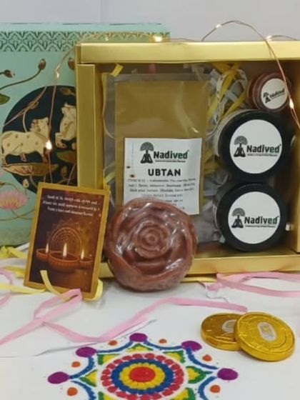The Nadived Ubtan Gift Set, shown here with festive diyas and rangoli. This hamper is a wonderful way to share the gift of a traditional royal bath, or 'Shahi Snan'.