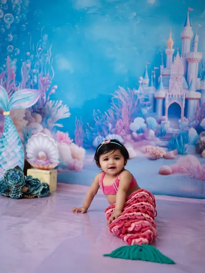 A full-length portrait of our crawling mermaid, complete with a sparkling tail. I provide a variety of costumes to make your child's fairytale dreams come true.