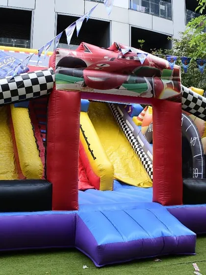 The full view of the impressive race car themed bouncy castle and slide. This single piece provides a huge amount of entertainment value.