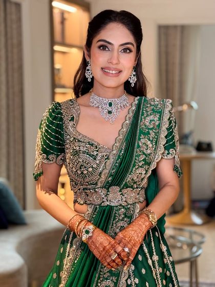 Kicking off the wedding festivities with a traditional puja. The bride looks stunning in an emerald green lehenga with soft, minimal makeup.