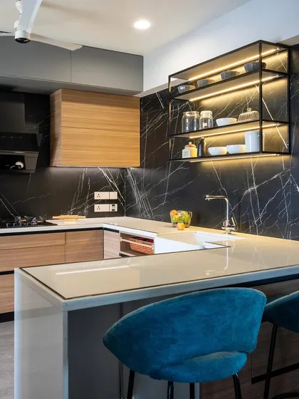 I love the drama of a bold kitchen. Here, the striking black marble backsplash and warm wood cabinetry create a sophisticated contrast, while the island with comfortable seating makes it an inviting social hub. This is a space designed for both cooking and conversation.