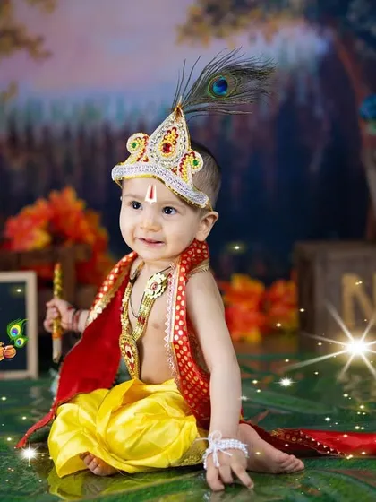 A magical portrait of little Krishna celebrating his first birthday. The sparkling lights and chalkboard sign add a special touch to the celebration.