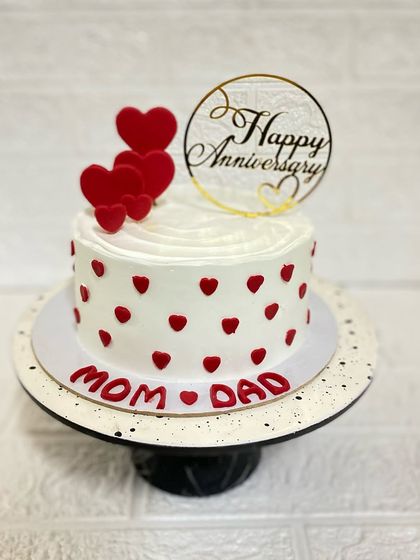 For Mom and Dad's anniversary. This simple and sweet cake is covered in tiny red hearts, showing that love is in the little details.