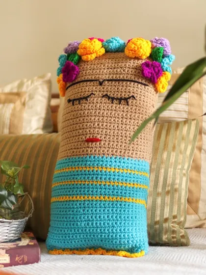 The Frida cushion on a grey day, bringing its own sunshine. The bright flowers in her hair are a reminder of color and joy, even when the sky is overcast.