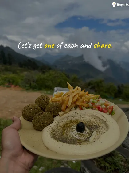 "Let's get one of each and share." A delicious plate of food with a mountain view. This is the foodie philosophy on my trips, where we taste everything together.