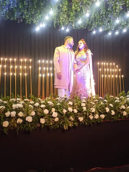 The couple posing on their beautifully decorated stage. A perfect setting for a perfect performance.