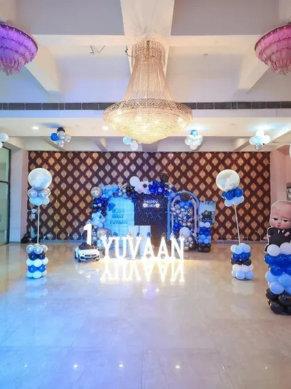 A full view of the "Boss Baby" party hall, with themed balloon pillars and character cutouts spread throughout the space.