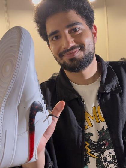 Samay Raina himself holding up his custom "Unfiltered" sneaker.