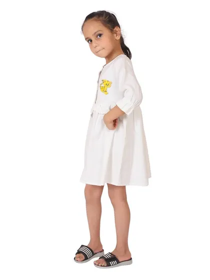 A side-view of a white frock, showing the sleeve details and fit. We capture multiple angles for a complete product view.