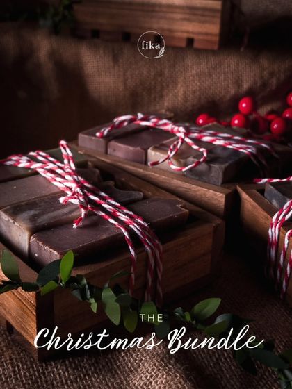 My limited edition Christmas Soap Bundles are wrapped with extra joy. This image shows the bundles of mini soaps in their keepsake wooden dishes, tied with festive twine and ready to be gifted.