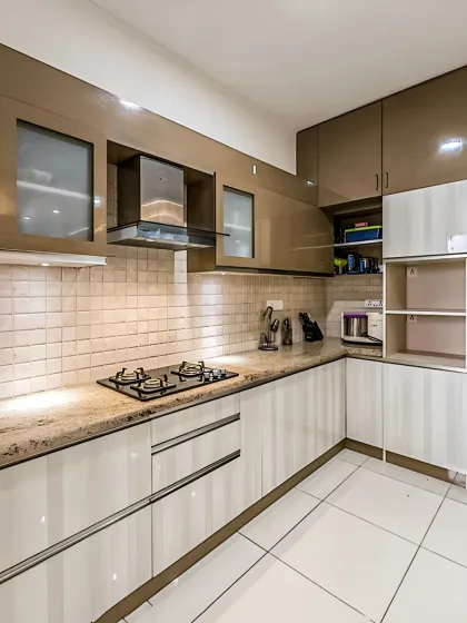 A sophisticated two-tone kitchen with glossy brown upper cabinets and off-white lower units. The design includes frosted glass sections and a tall unit for appliances, creating a practical and elegant cooking space.
