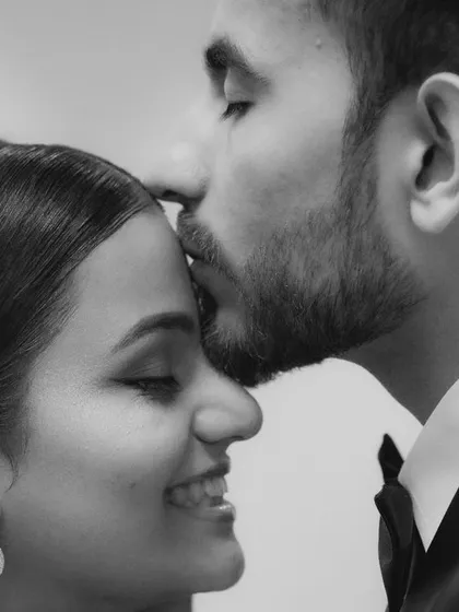 A tender forehead kiss, rendered in emotional black and white. This style strips away distractions and focuses purely on the loving gesture.