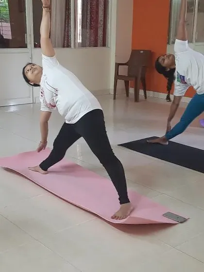 A duplicate of image 47, showing the Triangle Pose practice.