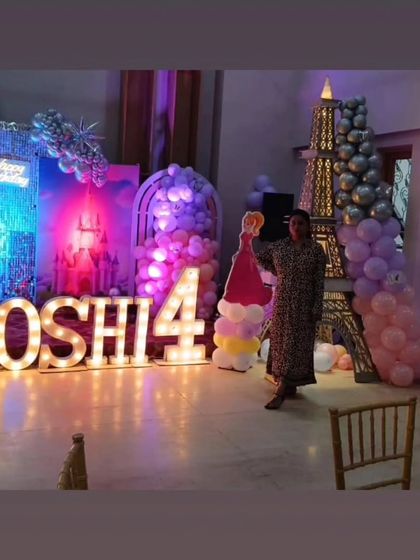 The planner posing with the grand princess party setup, showcasing the scale of the event we organized.