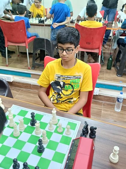 A student focuses intently on the board during a tournament. These events are a great way for kids to build confidence and experience the thrill of competitive chess.
