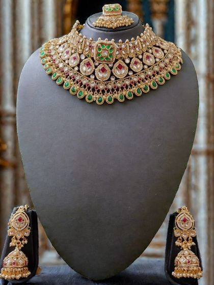 The full view of this traditional red and green kundan set, a popular choice for brides.