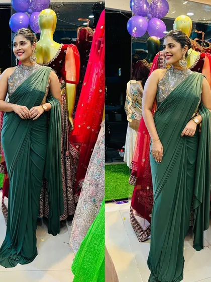 Our popular green drape saree is available to buy or to rent. It features a high neck embellished blouse that adds a touch of class to the modern silhouette.