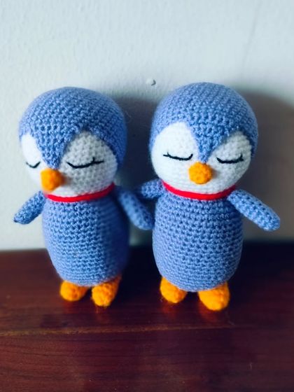 A pair of sleeping penguins in a lovely shade of blue.