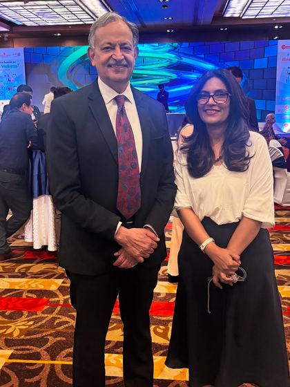 With a fellow professional at a healthcare event. Networking with other experts helps me stay updated and ensures my clients receive the most comprehensive care.