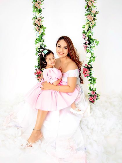 A mother's love in a single photo. This tender moment between a mother and her daughter on our floral swing is simply precious.