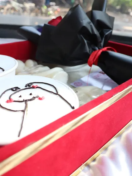 A side view of the "Decadent Love" hamper, highlighting the elegant red and gold gift box.