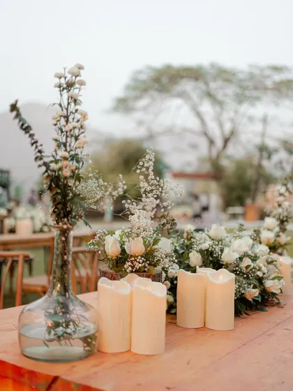 A close-up of the elegant table decor, featuring white flowers and candles. We believe in capturing the small details that contribute to the overall beauty and atmosphere of the wedding.