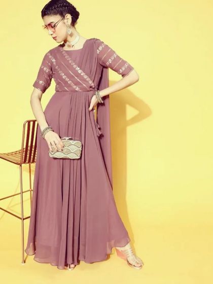 This mauve saree-dress is a modern, hassle-free alternative to a traditional saree. It is a single piece with a pre-draped pallu, making it incredibly easy to wear while still looking elegant.