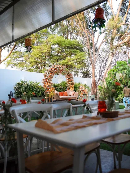 An engagement party setup in the covered dining area of our Backyard venue. The warm, earthy tones of the floral decor create a cozy and intimate setting.