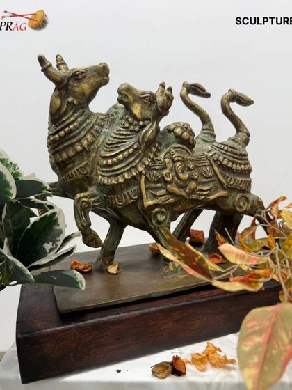 Another angle of the twin Nandi sculpture, showing its solid form and the beautiful patina of the brass.