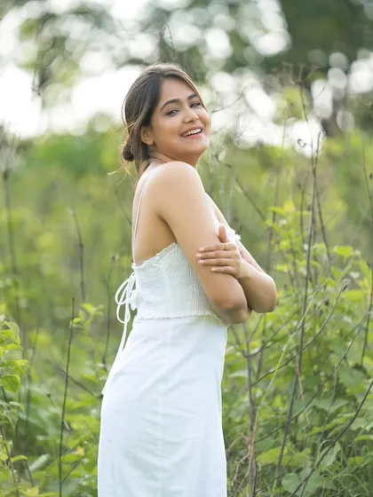 A relaxed and happy pose in a simple white dress, perfect for a lifestyle portfolio.