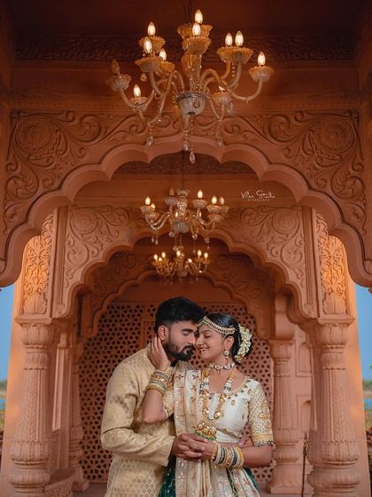 I used the intricate arches and warm chandeliers of the palace to frame this intimate couple's portrait. The lighting creates a soft, romantic glow, highlighting the elegance of their traditional attire.
