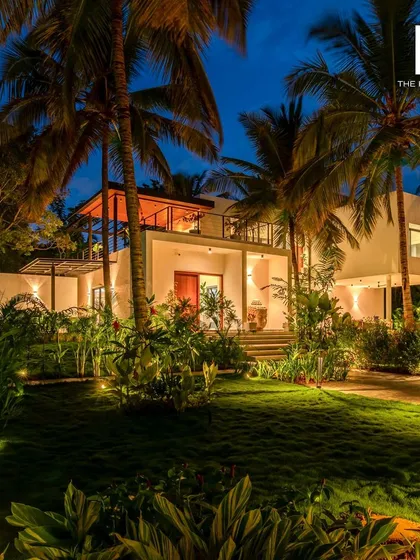 Imagine your guests unwinding here. This is a luxury villa we designed, illuminated at twilight to highlight its architectural beauty and integration with the lush landscape. We focus on creating photogenic spaces that attract bookings and create unforgettable stays.
