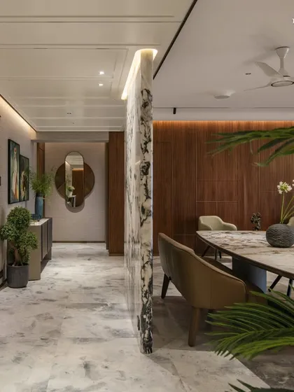 The entryway of this residence unfolds into the dining area, where intimacy takes center stage. The design embraces openness and flow, with surfaces in Italian marble and limewash bringing a tactile calm, while a sculptural dining table anchors the room.