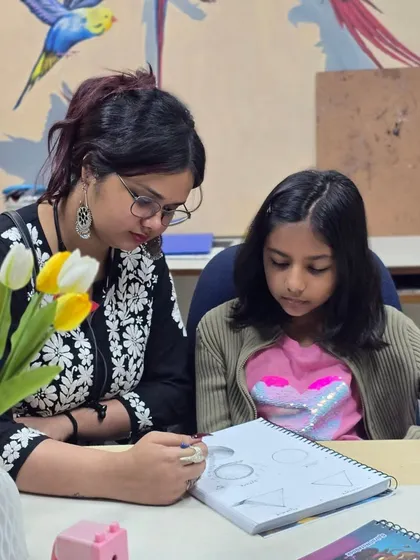 An instructor helps a young student with the basics of drawing. Our foundational classes are perfect for kids and beginners who are just starting their artistic journey.