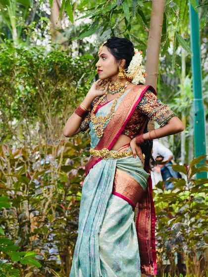 This series showcases a model in a beautiful light blue saree, adorned with a full temple jewellery set. The outdoor setting highlights the richness of the antique gold finish.