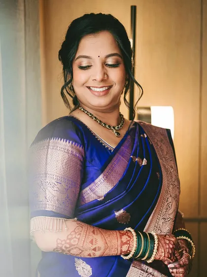 The second look for the engagement, a classic blue saree. The makeup was kept versatile to work across all three outfit changes.