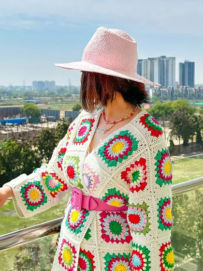 A side profile showing the details of the crochet cardigan and the summer hat. The textures work so well together.