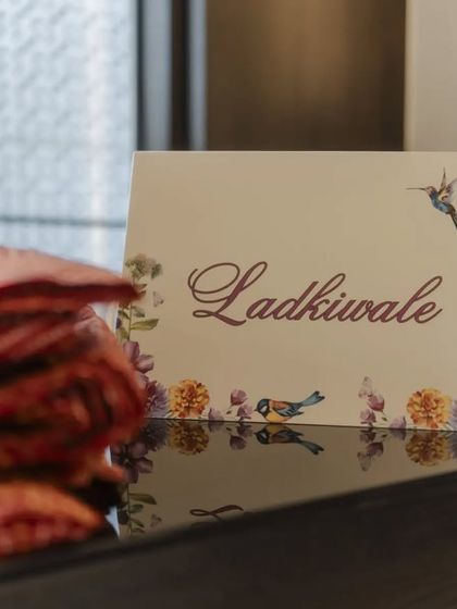 A beautifully designed sign for the "Ladkiwale" (bride's side) at the Saafa Bandhi station. These small, artistic touches help organize the event while adding to the overall aesthetic.