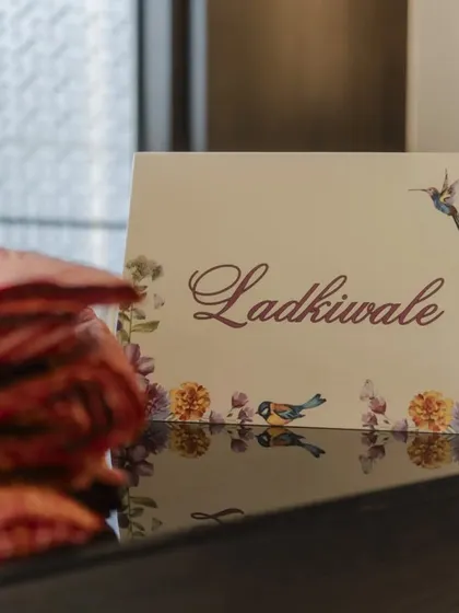 A beautifully designed sign for the "Ladkiwale" (bride's side) at the Saafa Bandhi station. These small, artistic touches help organize the event while adding to the overall aesthetic.