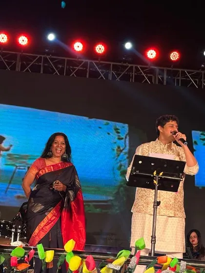A candid moment of laughter on stage in Davangere. These unscripted interactions are often the most memorable parts of a live concert.