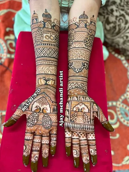 An intricate bridal design with matching peacocks on the palms and detailed architectural patterns on the forearms.